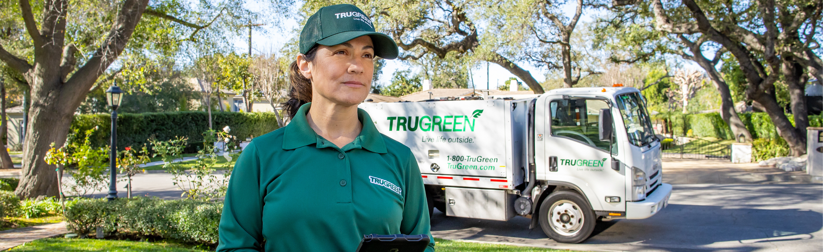 Lawn care specialist standing by truck